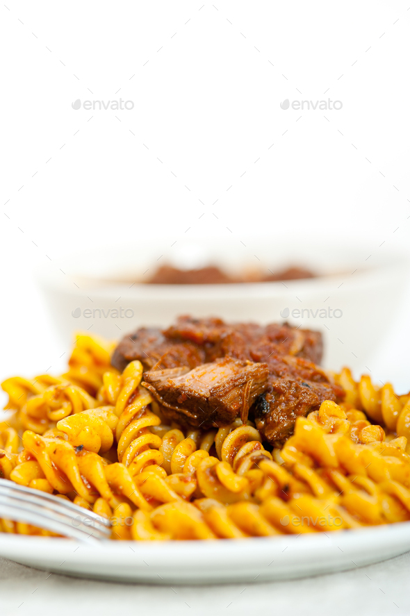 fusilli pasta with neapolitan style ragu meat sauce Stock Photo by keko64